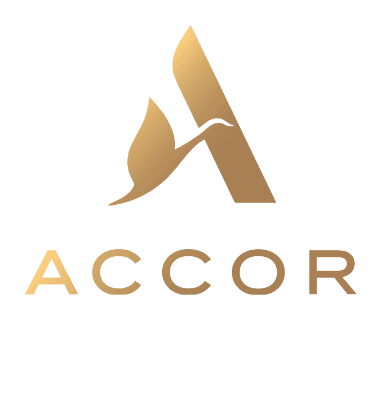 Gold Accor logo featuring a stylized letter A with a bird silhouette, evoking the elegance of electric cars, above the word ACCOR in gold capital letters, all on a transparent background.