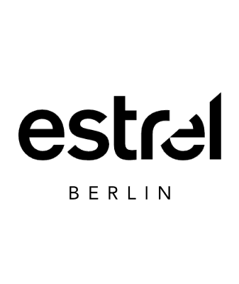 A hand holds a magnifying glass, enlarging the word JOB in bold letters, signifying a search for employment or job opportunities—perhaps in emerging fields like electric cars or free loading stations. The image is in black and white.