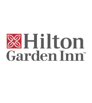 The Hilton Garden Inn logo features a red square with a white floral motif, followed by bold black letters—and selected locations offer free loading stations for charging electric cars.