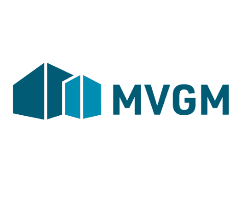 MVGM logo featuring stylized blue geometric shapes resembling buildings to the left, with the letters MVGM in bold blue font to the right—highlighting their commitment to EV and electric cars innovation.
